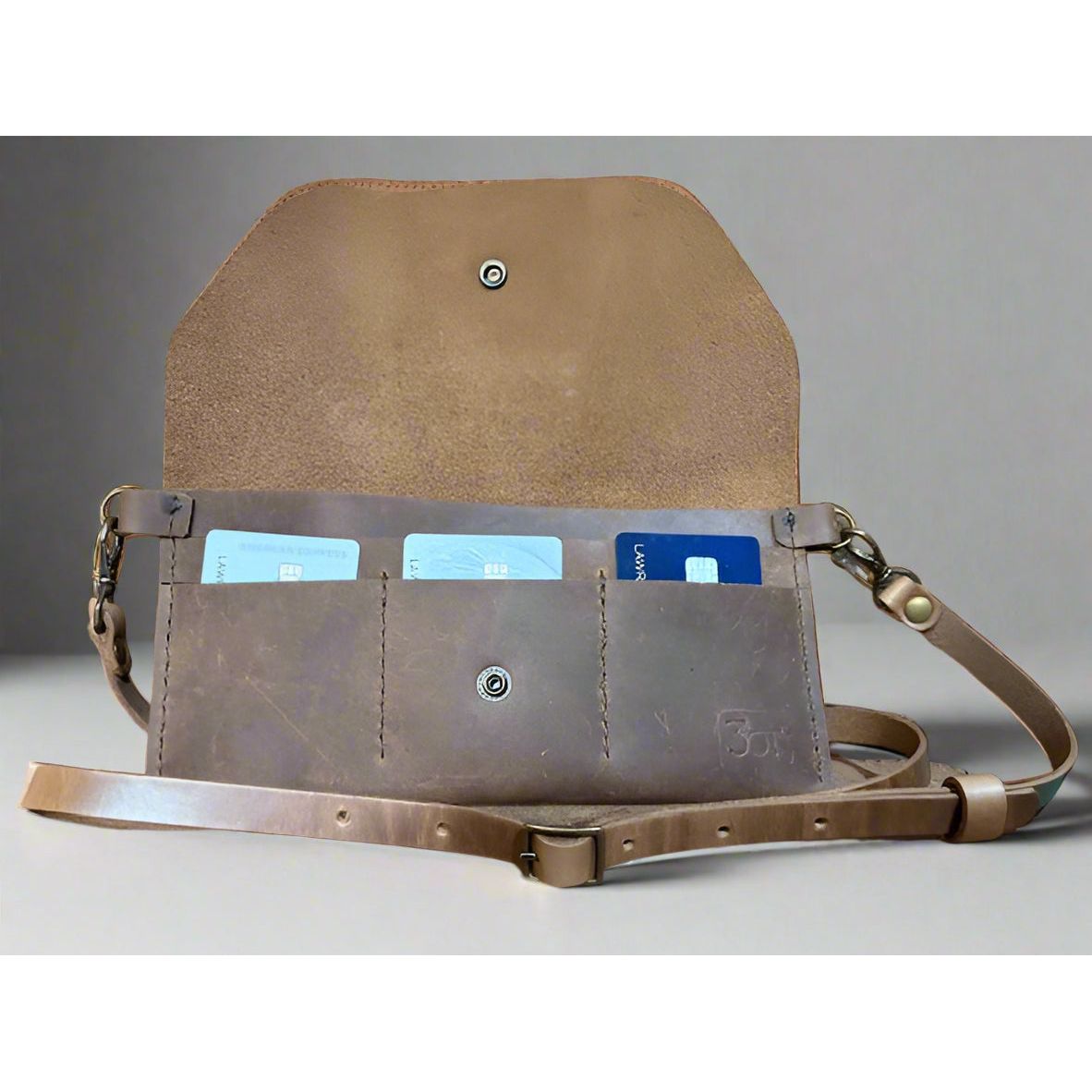 Brown leather bag with card slots and snap closure