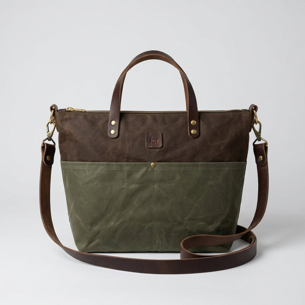 A brown and Sage two-tone tote bag with a top handle, zipper closure, and adjustable shoulder strap.